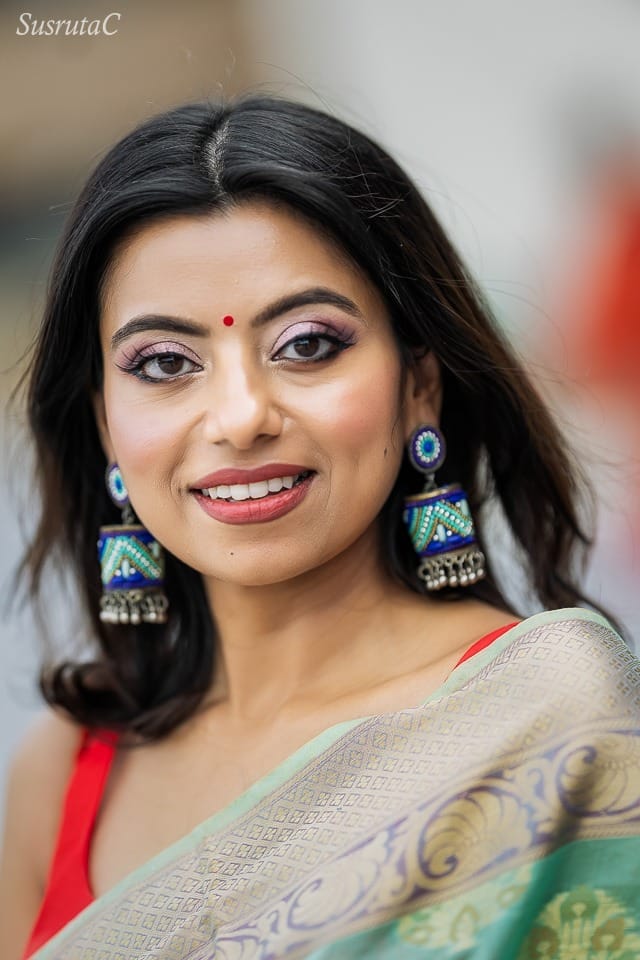 Outdoor head and shoulder portrait of a young woman wearing beautiful earrings